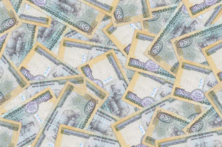 100 Nepalese rupees bills lies in big pile. Rich life conceptual background. Big amount of money