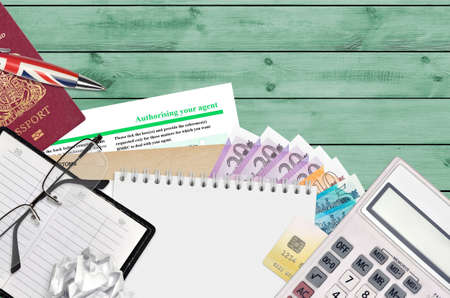 English form 64-8 Authorizing your agent from HM revenue and customs lies on table with office...