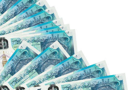 5 British pounds bills lies isolated on white background with copy space stacked in fan close up....