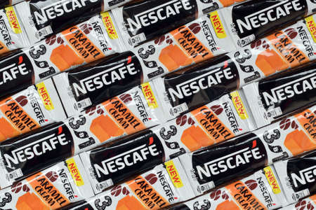 KHARKOV, UKRAINE - MARCH 21, 2020: Many Nescafe caramel cream coffee sticks. Nescafe is a brand of coffee made by Nestle, swiss multinational conglomerate corporationのeditorial素材