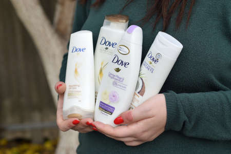 KHARKOV, UKRAINE - OCTOBER 16 2020: Young girl holds Dove products. Introduced to the British market in 1955, Dove is a personal care brand now owned by Unilever and sold in more than 80 countriesのeditorial素材