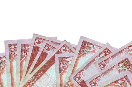 20 Nepalese rupees bills lies on bottom side of screen isolated on white background with copy space....