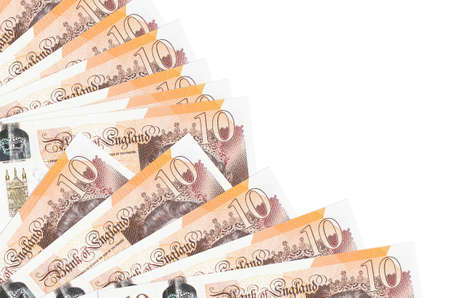 10 British pounds bills lies isolated on white background with copy space stacked in fan close up. Payday time concept or financial operationsの写真素材