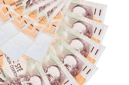 200 Czech korun bills lies isolated on white background with copy space stacked in fan shape close...