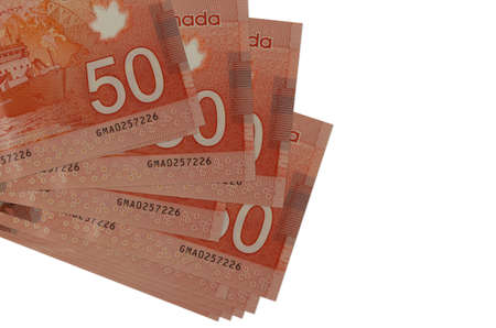 50 Canadian dollars bills lies in small bunch or pack isolated on white. Mockup with copy space. Business and currency exchange conceptの写真素材