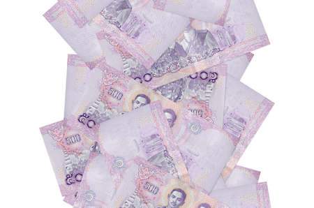 500 Thai baht bills flying down isolated on white. Many banknotes falling with white copy space on...