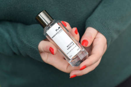 KHARKOV, UKRAINE - OCTOBER 16 2020: Young girl holds Mancera roses vanille perfume bottle. Mancera is a french perfume brandのeditorial素材