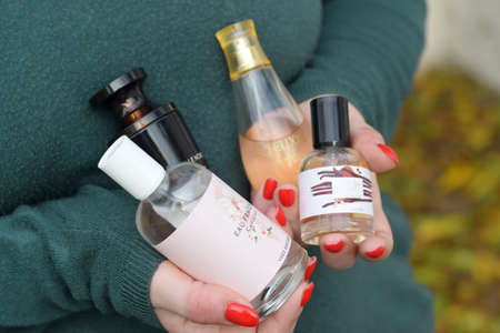 KHARKOV, UKRAINE - OCTOBER 16 2020: Young girl holds Yves Rocher production in bottles. Yves Rocher is a worldwide cosmetics and beauty brand founded in 1959 in franceのeditorial素材