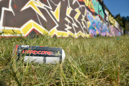KHARKOV, UKRAINE - AUGUST 16, 2020: Used Montana hardcore aerosol spray can against graffiti paintings. MTN or Montana-cans is manufacturer of high pressure spray paint goodsのeditorial素材