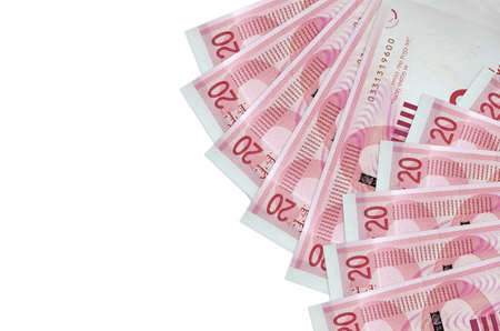 20 Israeli new shekels bills lies isolated on white background with copy space. Rich life conceptual...