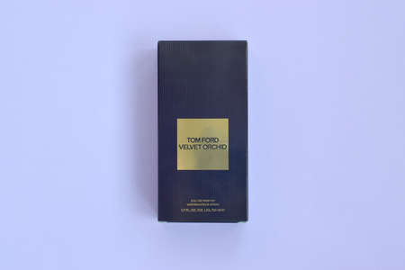 KHARKOV, UKRAINE - FEBRUARY 29, 2020: Tom Ford velvet orchid fragrance perfume bottle lies on light lilac background. Tom Ford is American fashion designer launched his eponymous luxury brand in 2006のeditorial素材
