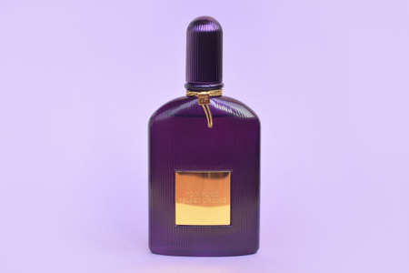 KHARKOV, UKRAINE - FEBRUARY 29, 2020: Tom Ford velvet orchid fragrance perfume bottle lies on light lilac background. Tom Ford is American fashion designer launched his eponymous luxury brand in 2006のeditorial素材