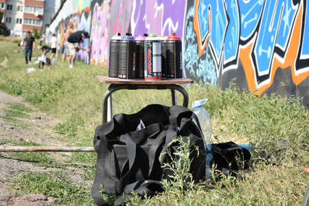 KHARKOV, UKRAINE - AUGUST 16, 2020: Used Montana black and hardcore aerosol spray cans against graffiti paintings. MTN or Montana-cans is manufacturer of high pressure spray paint goodsのeditorial素材