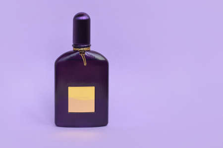 KHARKOV, UKRAINE - FEBRUARY 29, 2020: Tom Ford velvet orchid fragrance perfume bottle lies on light lilac background. Tom Ford is American fashion designer launched his eponymous luxury brand in 2006のeditorial素材