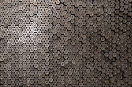 Pattern of 12 gauge cartridges for shotgun bullets. Shells for hunting rifle close up. Backdrop for...