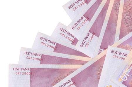10 Estonian kroon bills lies in different order isolated on white. Local banking or money making...