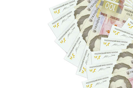 100 Ukrainian hryvnias bills lies isolated on white background with copy space. Rich life conceptual...