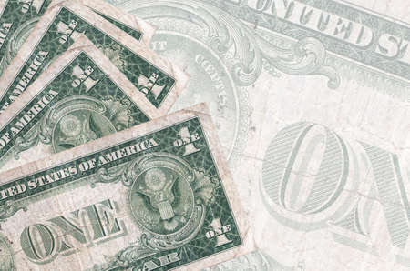 1 US dollar bills lies in stack on background of big semi-transparent banknote. Abstract business background with copy spaceの写真素材