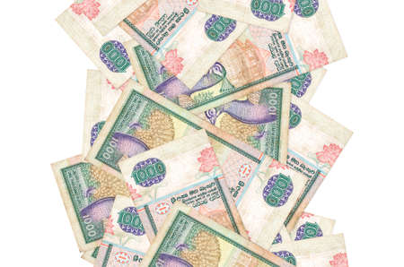 1000 Sri Lankan rupees bills flying down isolated on white. Many banknotes falling with white copy...