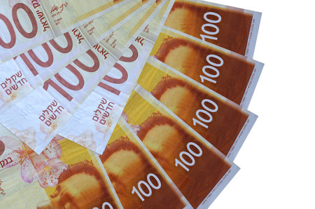 100 Israeli new shekels bills lies isolated on white background with copy space stacked in fan shape close up. Financial transactions conceptの写真素材