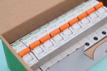 KHARKOV, UKRAINE - OCTOBER 29, 2020: Schneider electric circuit breakers box on light blue background. Schneider Electric is a French power engineering company, a manufacturer of electric equipmentのeditorial素材