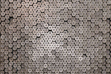Pattern of 12 gauge cartridges for shotgun bullets. Shells for hunting rifle close up. Backdrop for...