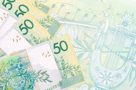 50 Belorussian rubles bills lies in stack on background of big semi-transparent banknote. Abstract business background with copy spaceの写真素材