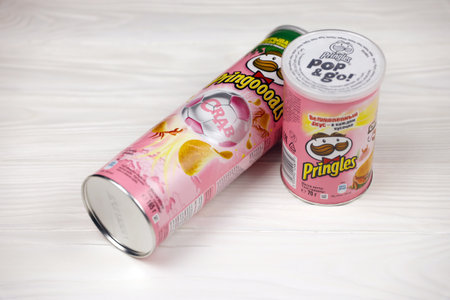 KHARKOV, UKRAINE - NOVEMBER 23, 2020: Pringles crab flavor. Cardboard tube cans with Pringles potato chips on white table. Pringles is a brand of potato snack chips owned by Kellogg Companyのeditorial素材