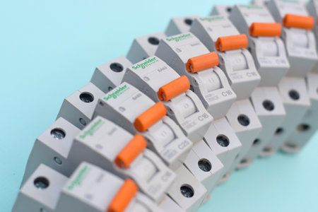 KHARKOV, UKRAINE - OCTOBER 29, 2020: Schneider electric circuit breakers on light blue background. Schneider Electric is a French power engineering company, a manufacturer of electric equipmentのeditorial素材