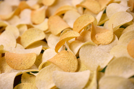 KHARKOV, UKRAINE - NOVEMBER 23, 2020: Many orange Pringles potato snack chips. Pringles is a brand of potato snack chips owned by Kellogg Companyのeditorial素材