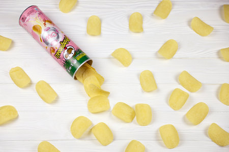 KHARKOV, UKRAINE - NOVEMBER 23, 2020: Pringles crab flavor. Cardboard tube can with Pringles potato chips on white table. Pringles is a brand of potato snack chips owned by Kellogg Companyのeditorial素材