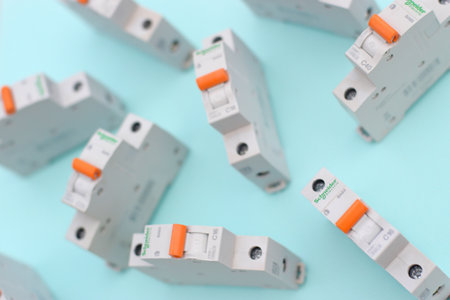 KHARKOV, UKRAINE - OCTOBER 29, 2020: Schneider electric circuit breakers on light blue background. Schneider Electric is a French power engineering company, a manufacturer of electric equipmentのeditorial素材