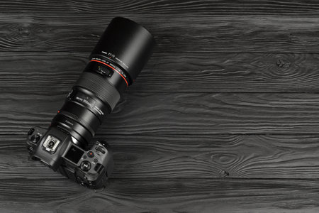 KHARKOV, UKRAINE - NOVEMBER 23, 2020: Canon EOS R photocamera and mount adapter EF - EOS R with...