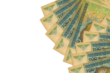 200 Uzbekistani som bills lies isolated on white background with copy space. Rich life conceptual...