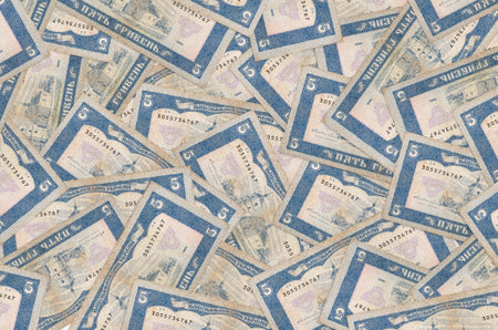 5 Ukrainian hryvnias bills lies in big pile. Rich life conceptual background. Big amount of moneyの写真素材