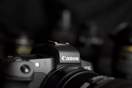 KHARKOV, UKRAINE - NOVEMBER 23, 2020: Canon EOS R photocamera with Canon lenses on black table. Canon EOS R is 30mp full-frame mirrorless interchangeable-lens camera launched by Canon in 2018のeditorial素材