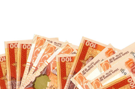 100 Sri Lankan rupees bills lies on bottom side of screen isolated on white background with copy space. Background banner template for business concepts with moneyの写真素材