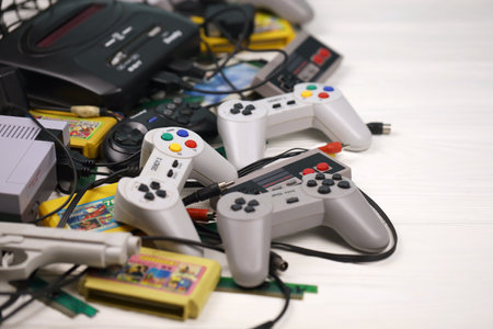 KHARKOV, UKRAINE - DECEMBER 27, 2020: Pile of old 8-bit video game consoles and many gaming...