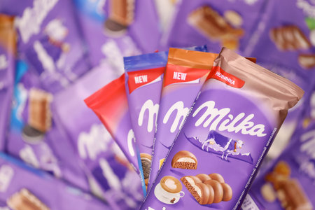 KHARKOV, UKRAINE - DECEMBER 8, 2020: Many wrappings of purple Milka chocolate. Milka is a Swiss brand of chocolate confection manufactured internationally by company Mondelez Internationalのeditorial素材