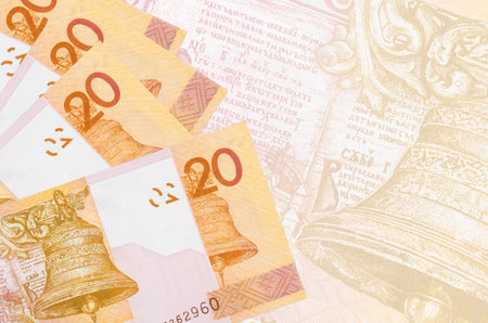 20 Belorussian rubles bills lies in stack on background of big semi-transparent banknote. Abstract...