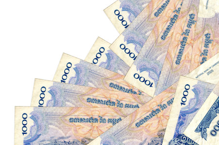 1000 Cambodian riels bills lies in different order isolated on white. Local banking or money making concept. Business background bannerの写真素材