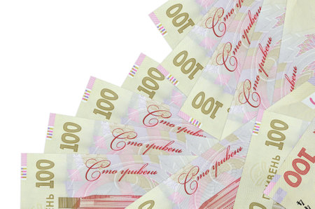 100 Ukrainian hryvnias bills lies in different order isolated on white. Local banking or money...