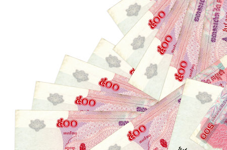 500 Cambodian riels bills lies in different order isolated on white. Local banking or money making...
