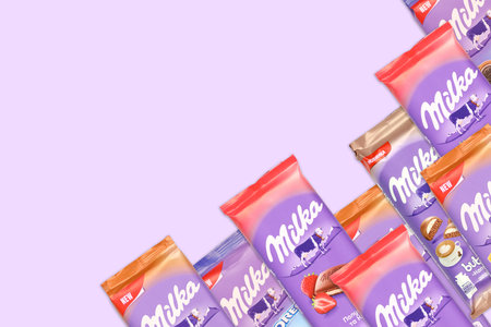 KHARKOV, UKRAINE - DECEMBER 8, 2020: Many purple Milka chocolate bars. Milka is a Swiss brand of chocolate confection manufactured internationally by company Mondelez Internationalのeditorial素材