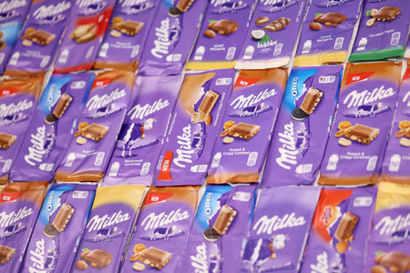 KHARKOV, UKRAINE - DECEMBER 8, 2020: Many wrappings of purple Milka chocolate. Milka is a Swiss brand of chocolate confection manufactured internationally by company Mondelez Internationalのeditorial素材