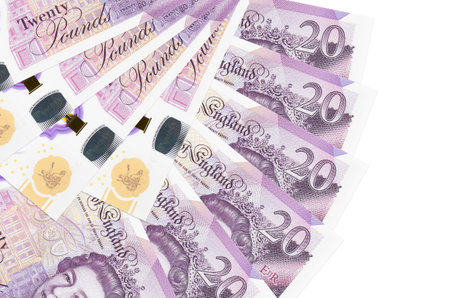 20 British pounds bills lies isolated on white background with copy space stacked in fan shape close up. Financial transactions conceptの写真素材