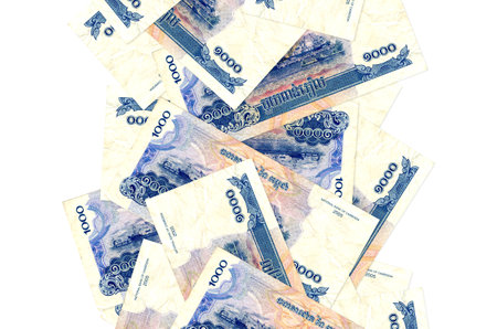 1000 Cambodian riels bills flying down isolated on white. Many banknotes falling with white copy space on left and right sideの写真素材