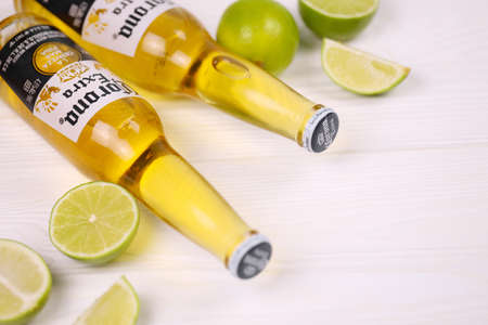 KHARKOV, UKRAINE - DECEMBER 9, 2020: Bottles of Corona Extra Beer with lime slices. Corona produced by Grupo Modelo with Anheuser Busch InBev is the most popular imported beer in the USのeditorial素材