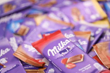 KHARKOV, UKRAINE - DECEMBER 8, 2020: Many wrappings of purple Milka chocolate. Milka is a Swiss...