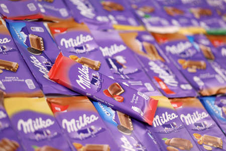 KHARKOV, UKRAINE - DECEMBER 8, 2020: Many wrappings of purple Milka chocolate. Milka is a Swiss brand of chocolate confection manufactured internationally by company Mondelez Internationalのeditorial素材